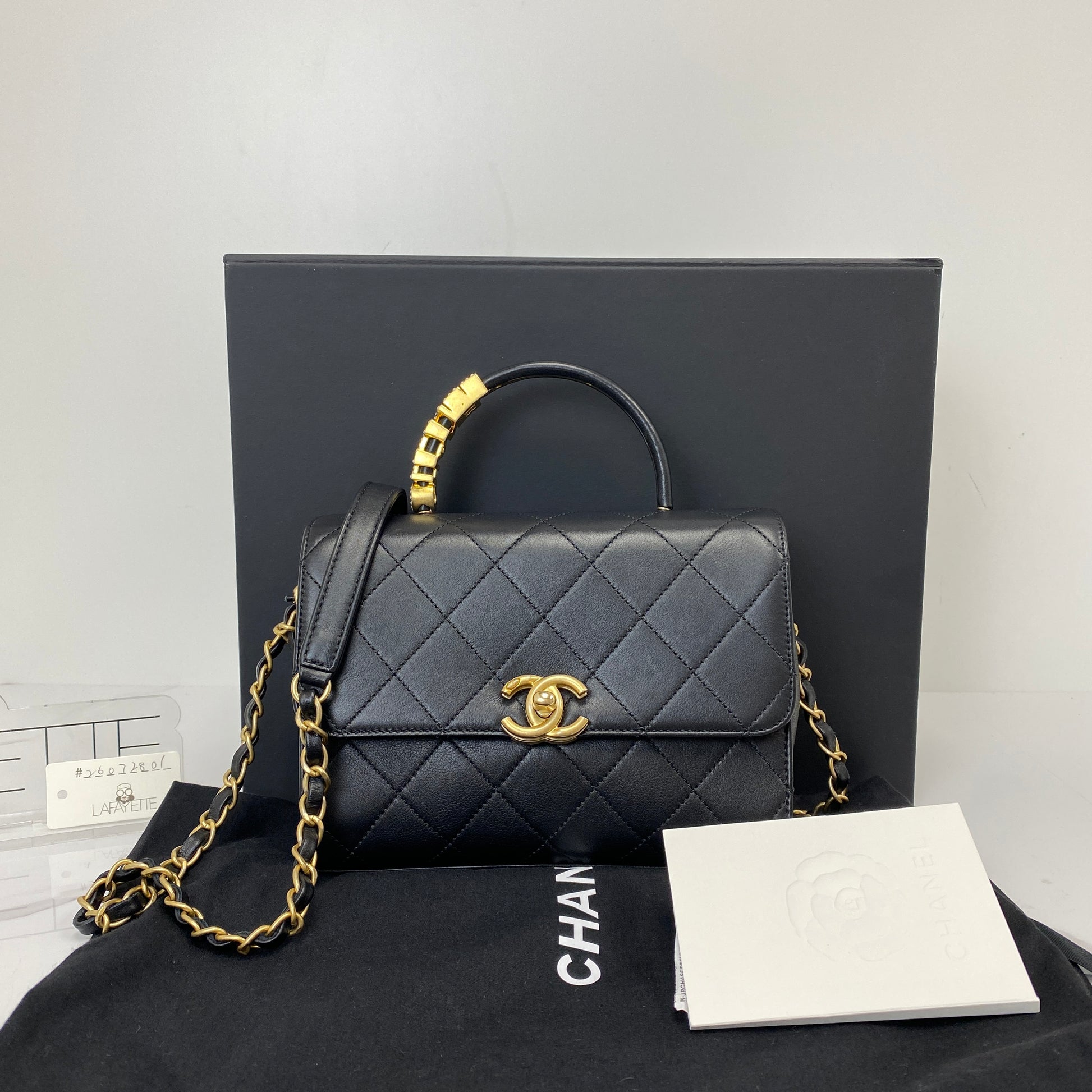 Chanel top handle flap bag shown with its box, dustbag and authenticity card