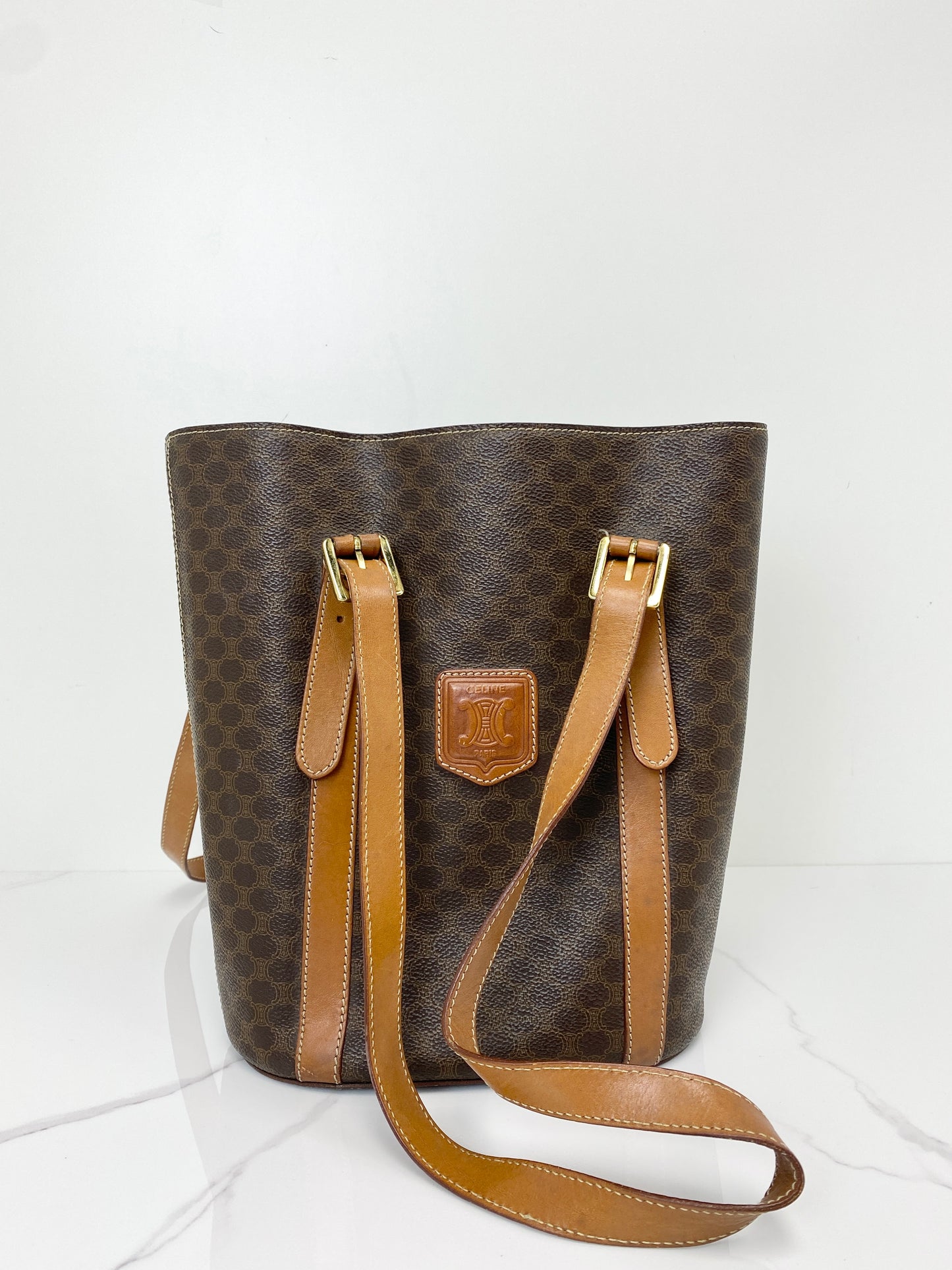 Celine Macadam bucket bag in brown coated canvas with tan leather drawstring straps