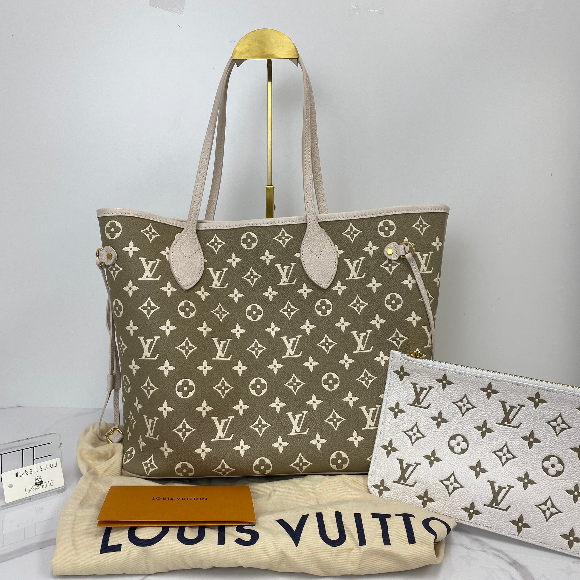 Louis Vuitton Neverfull MM shown with its matching removable pouch and dustbag