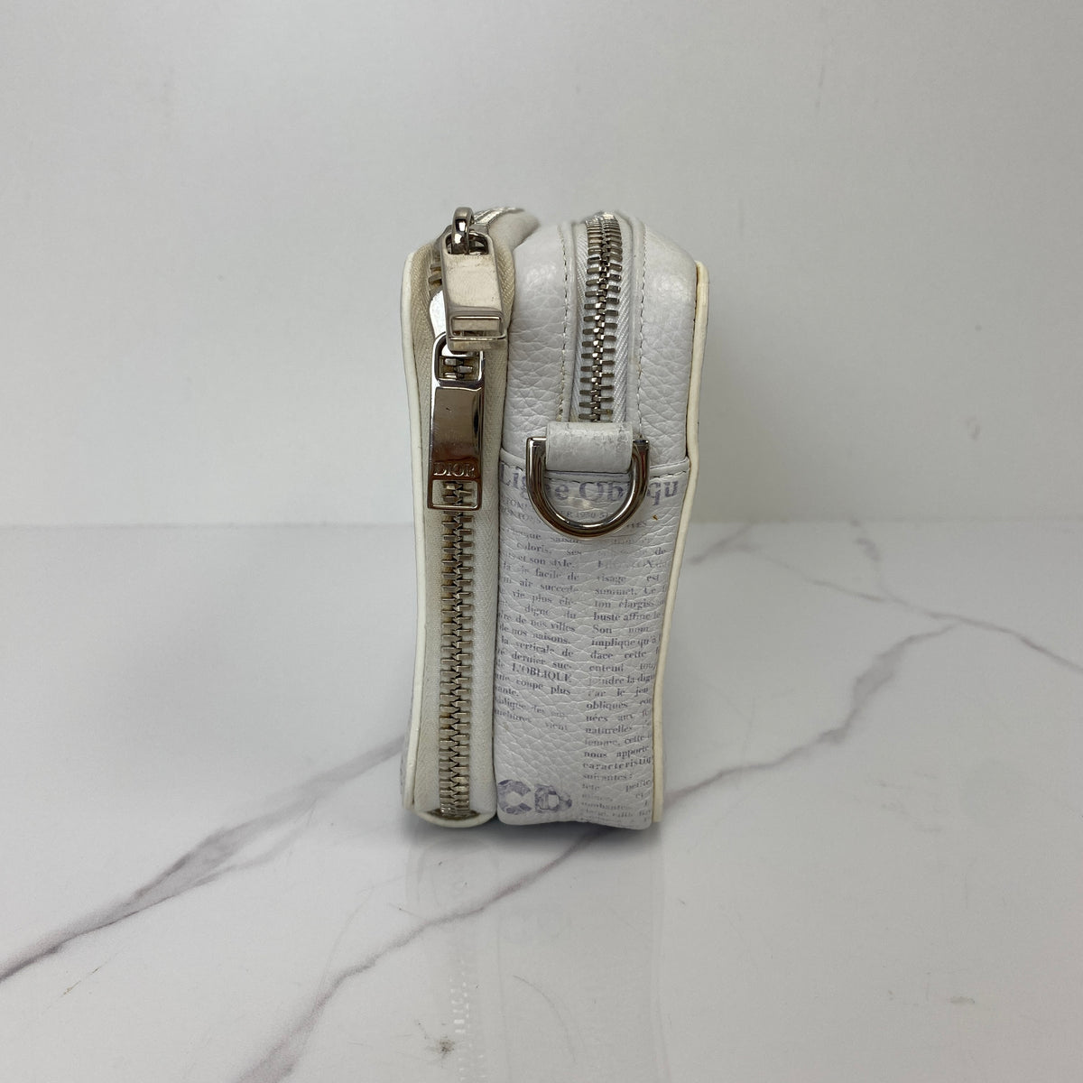Christian Dior x Daniel Arsham Newspaper Messenger Bag, white and black newspaper-print calfskin, silver-tone hardware — detail view 2
